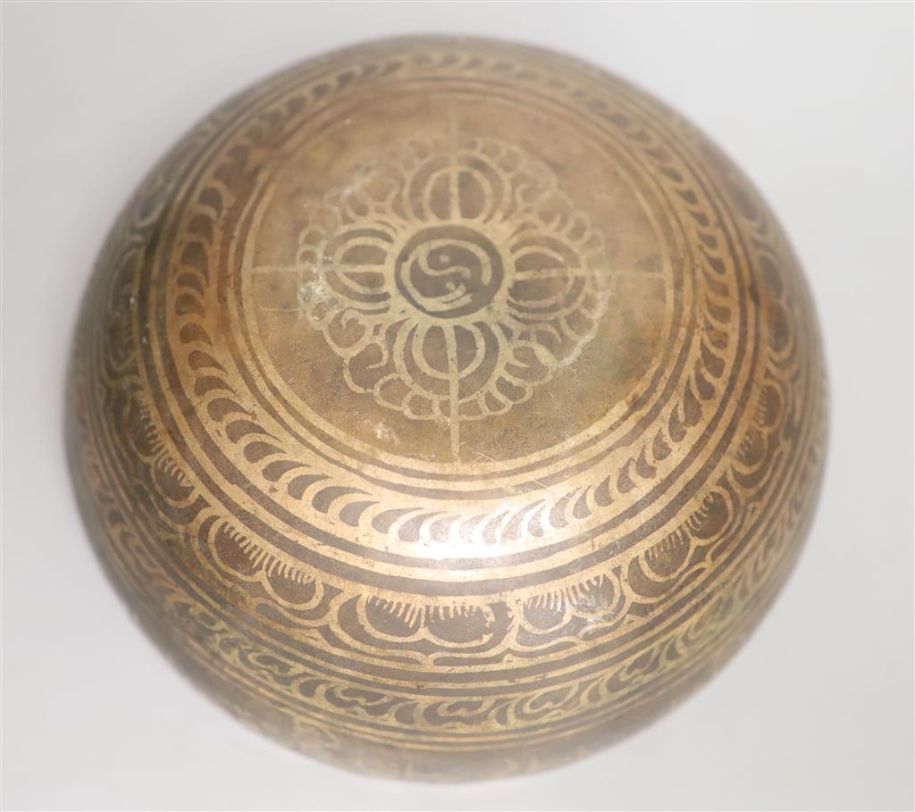 A Middle Eastern white metal and copper damascened bell, banded with foliate patterns and Arabic script Dia 18cm